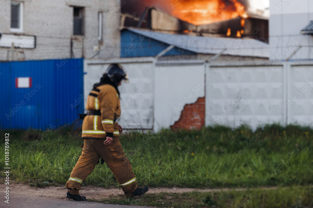 Group of fire men in uniform during fire fighting operation in the city streets, firefighters with the fire engine truck vehicle in the background, emergency and rescue, fire drill, exercise training Group of fire men in uniform during fire fighting operation in the city streets, firefighters with the fire engine truck vehicle in the background, emergency and rescue, fire drill, exercise training