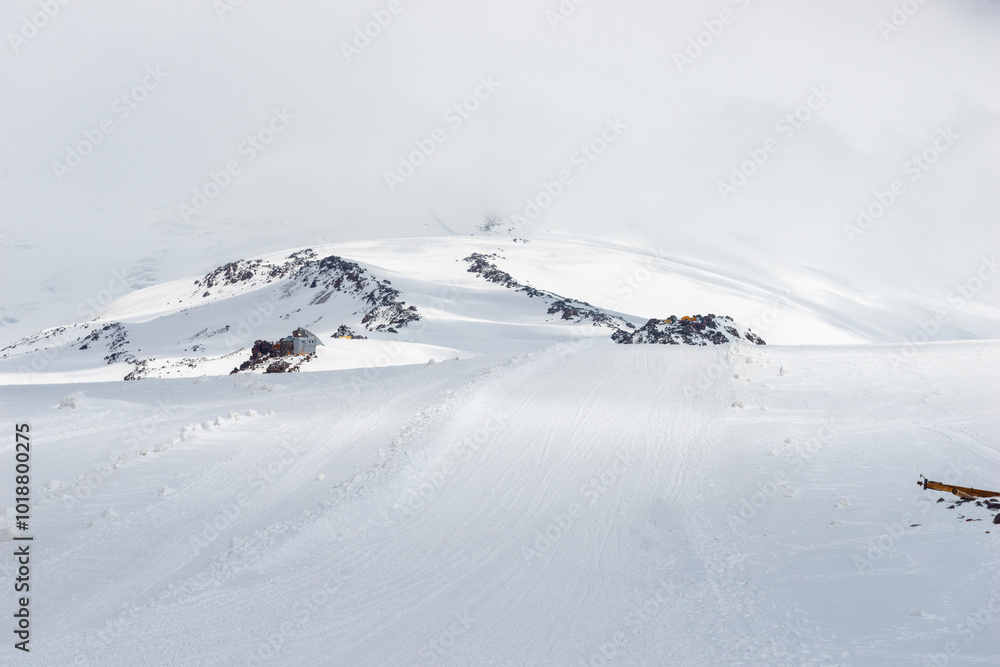 A ski slope in a snowstorm high in the mountains in bad weather. Elbrus. Caucasus A ski slope in a snowstorm high in the mountains in bad weather. Elbrus. Caucasus