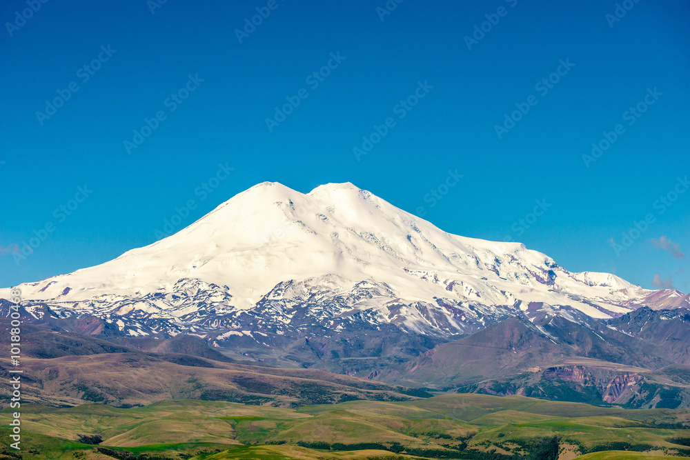 Picturesque view of the white peak of Mount Elbrus. View from the Kanjol plateau Picturesque view of the white peak of Mount Elbrus. View from the Kanjol plateau