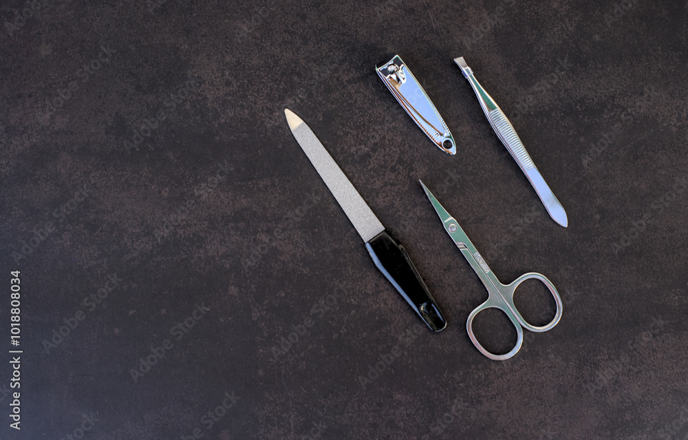 Set of manicure tools on dark background
