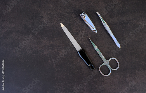 Set of manicure tools on dark background