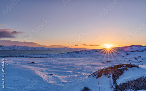 Bright dawn on the coast of the Barents Sea in the village of Teriberka in the Murmansk region of Russia.