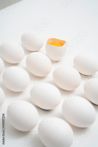 Whole and Cracked Eggs on White Background photo