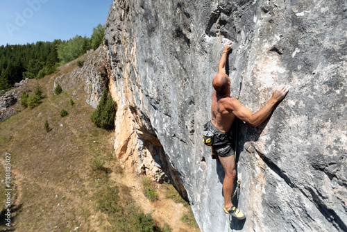 Man Rock Climbing Vertical Wall Outdoors photo