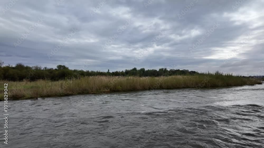 Panorama of riverbed of a clear mountain river, eroded riverbank, trees, clouds in the sky. Panorama of riverbed of a clear mountain river, eroded riverbank, trees, clouds in the sky.
