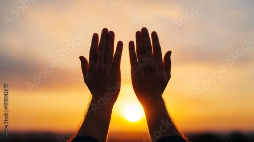 Hands in prayer raised toward a golden light, symbol of faith and hope, spiritual theme 