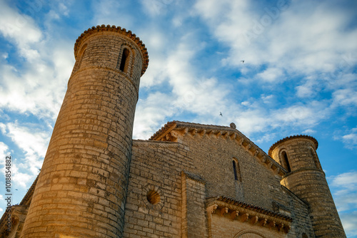 Facade of the Romanesque church of San Martín de Tours in Frómista, Palencia, Castilla y León, Spain with sunrise light and spectacular sky photo