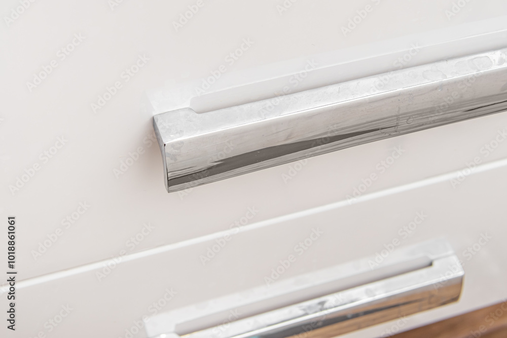 White plaque from hard water on handles of the bathroom cabinet. Dirty silver chrome handle White plaque from hard water on handles of the bathroom cabinet. Dirty silver chrome handle