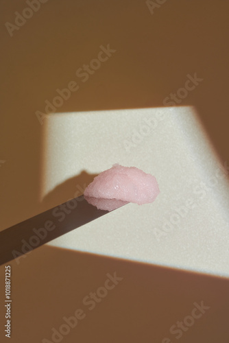 Close-Up of Pink Paste on a Wooden Spatula With Artistic Lighting photo