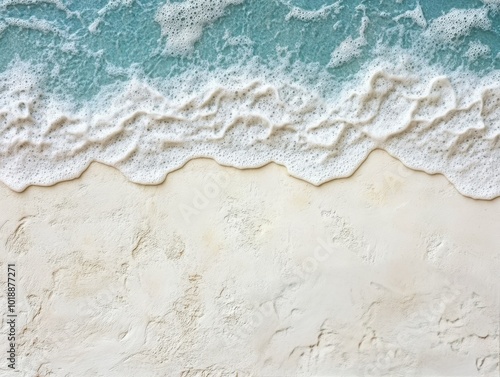 Gentle waves lapping the soft sandy beach under a bright blue sky