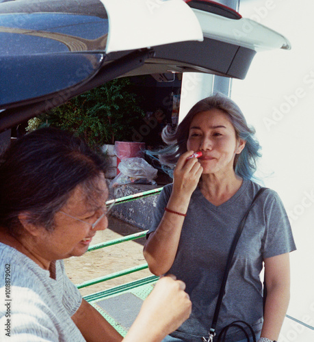 Happy couple being together at car trunk. Capturing candid moments photo