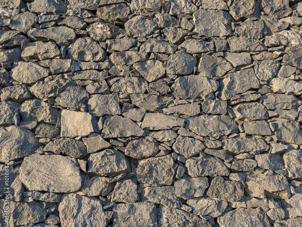 Background of a stacked stone wall made of volcanic rocks of different sizes
Background of a stacked stone wall made of volcanic rocks of different sizes