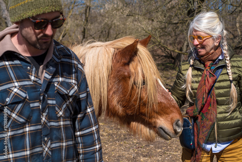 Mother and son with horse at the ranch photo