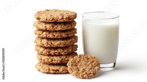 A stack of crunchy bran cereal biscuits placed on a white background, with a glass of milk positioned beside them.