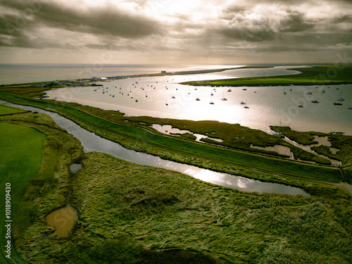 Aerial view of the magnificent Suffolk coastline at Aldeburgh showing boats in the estuary and a distant Martello tower. photo