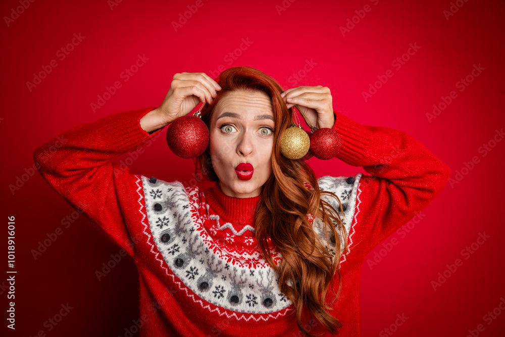 Photo portrait of foxy young girl plump lips wearing ugly sweater trying new jewelry xmas decor baubles isolated on red color background