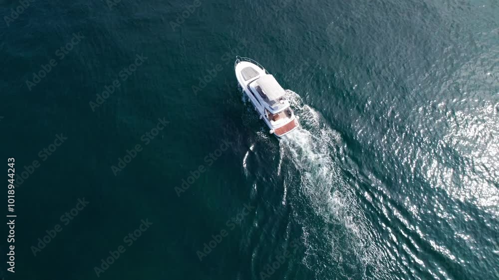 Luxury motor yacht in the blue sea. White boat moving faster diagonally top view. Luxury motor yacht in the blue sea. White boat moving faster diagonally top view.