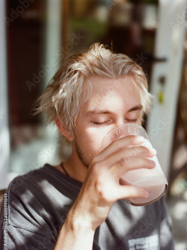 Man drinking milkshake photo