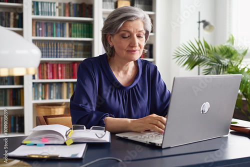 Senior Woman Working on Laptop in Cozy Home Office