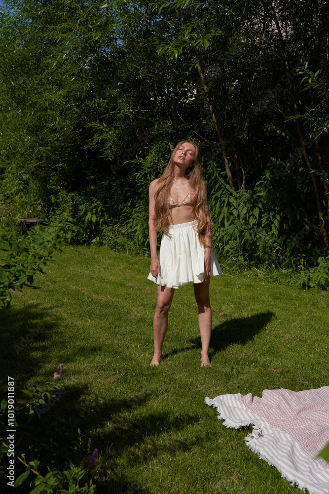 Girl Enjoying a Sunny Day in a Green Garden Girl Enjoying a Sunny Day in a Green Garden