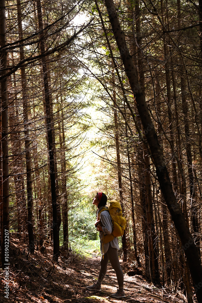 Young hiker with backpack enjoying time in forest Young hiker with backpack enjoying time in forest