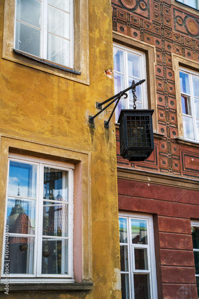 Historical Urban Architecture Featuring Colorful Facades and Window Reflections in Warsaw old town, Poland