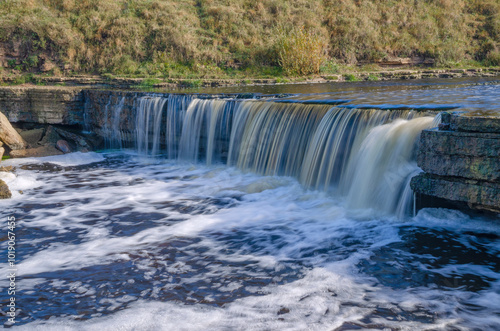 Tosnensky Hertovsky waterfall on a sunny October day. Leningrad Region