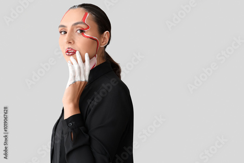 Young woman with painted fa...