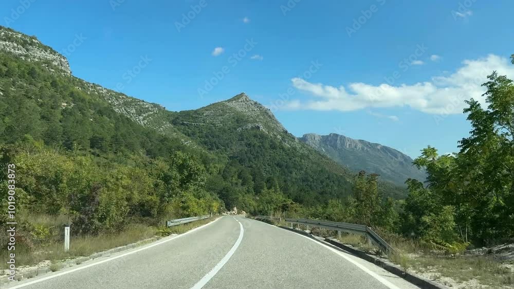 A narrow, steep, winding road with sharp turns in the mountains, the concept of careful driving in difficult conditions. A narrow, steep, winding road with sharp turns in the mountains, the concept of careful driving in difficult conditions.