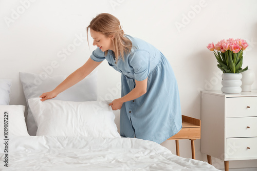 Pretty young woman putting ...