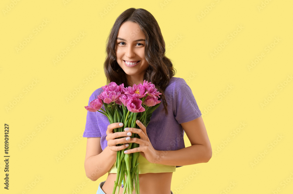 Young woman with tulips on yellow background Young woman with tulips on yellow background
