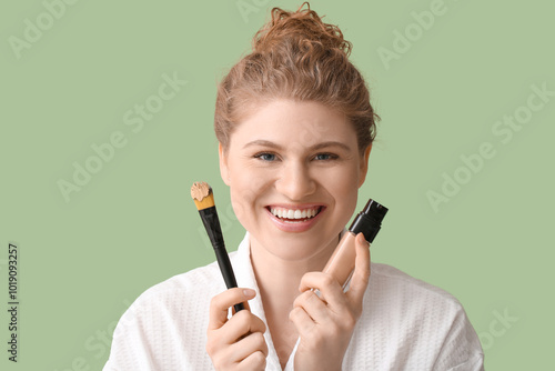 Happy young woman with bott...
