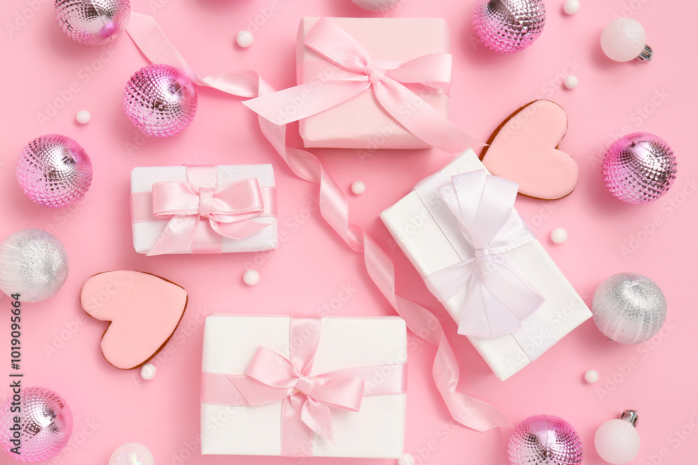 Christmas gift boxes with balls, cookies in shape of heart and ribbon on pink background Christmas gift boxes with balls, cookies in shape of heart and ribbon on pink background