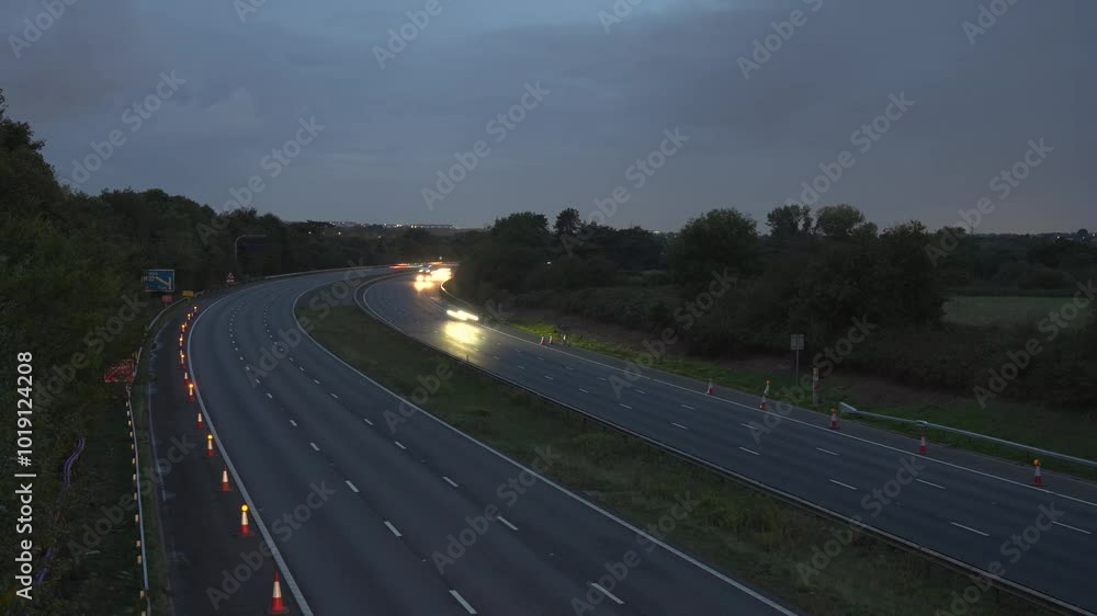 M4 Cars leaving light trails driving on motorway at dusk M4 Cars leaving light trails driving on motorway at dusk