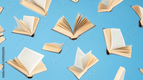 Open books and textbooks fly on a blue background copy space