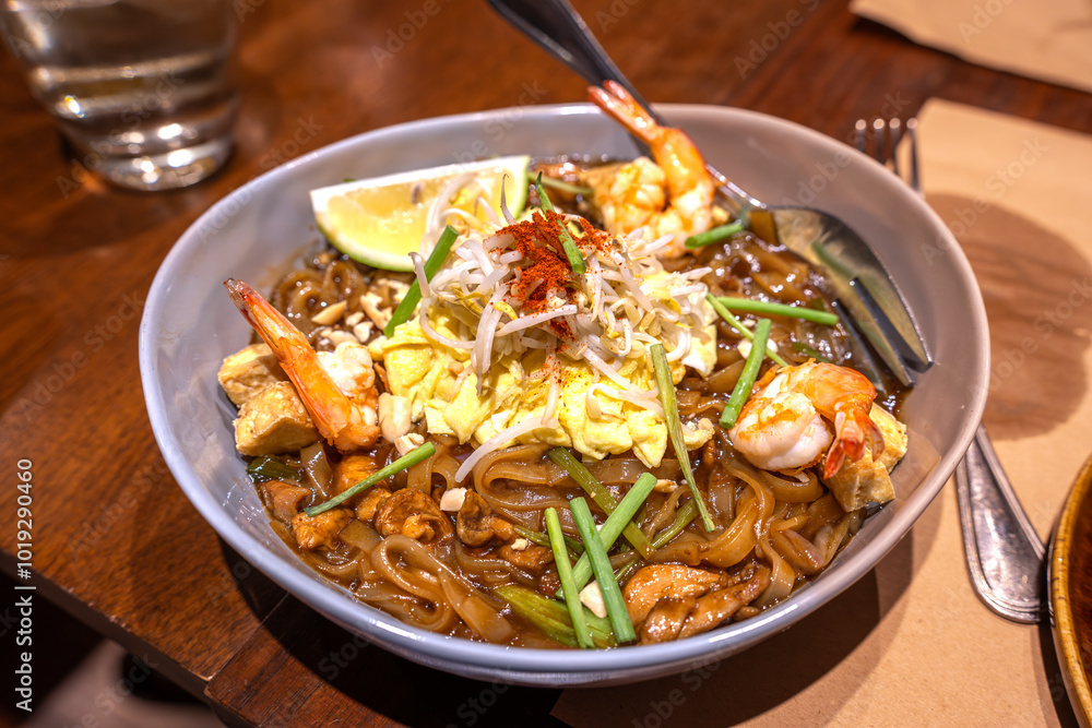 Pad Thai is a Thai noodle stir fry with a sweet-savoury-sour sauce scattered with crushed peanuts.
Pad Thai is a Thai noodle stir fry with a sweet-savoury-sour sauce scattered with crushed peanuts.