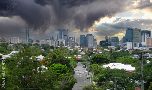 Heavy tropical storm clouds and rain over the city of Brisbane, Queensland, Australia with beams of sunlight