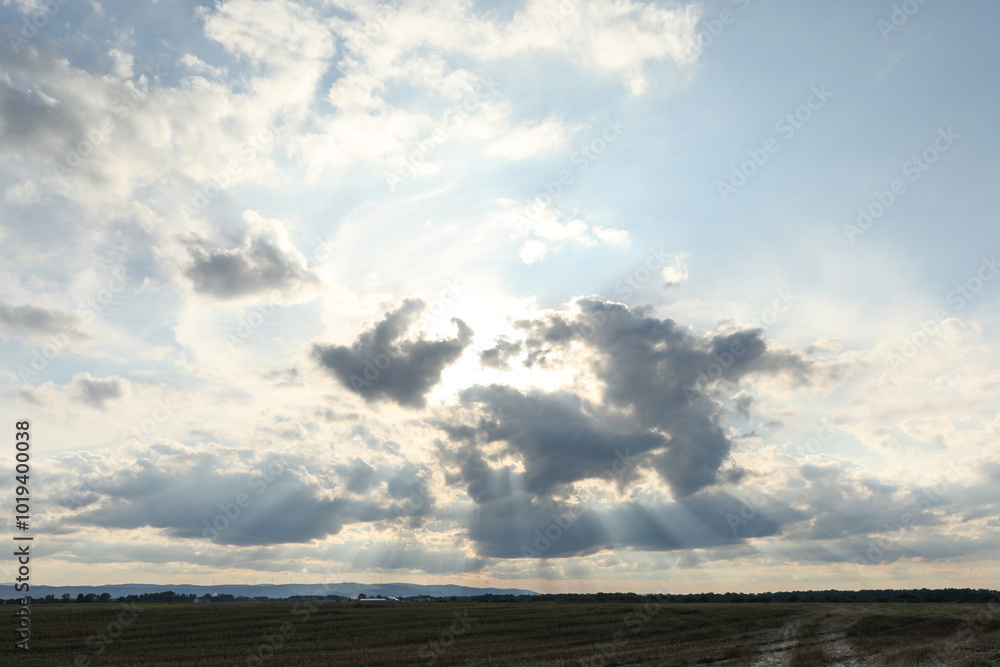 Sun shining through clouds on beautiful sky Sun shining through clouds on beautiful sky