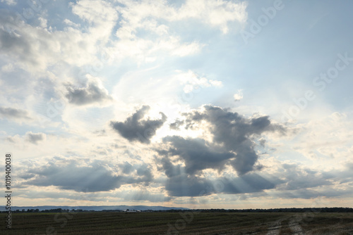 Sun shining through clouds on beautiful sky