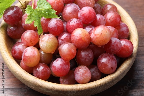 Fresh ripe grapes on wooden table, closeup