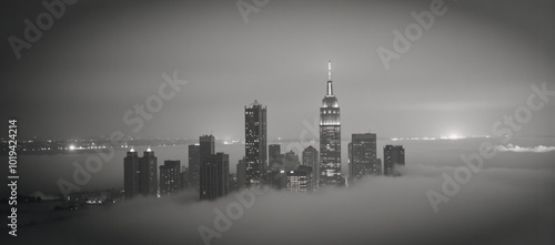 Monochrome cityscape mystical towering skyscrapers rise above the fog creating an enigmatic ambiance photo