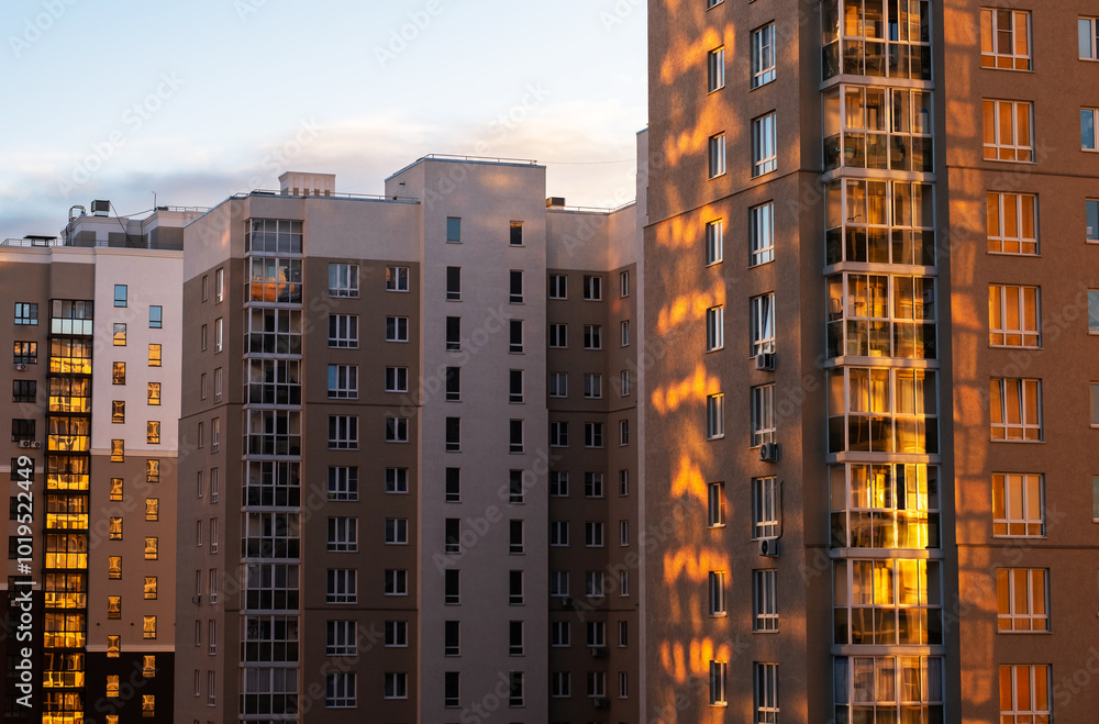 Fototapeta premium High rise community housing on sunset with sun reflection.