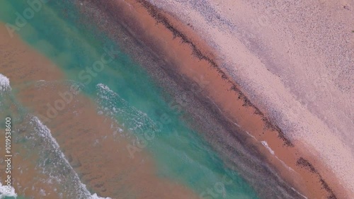 Aerial waves over rocky lake shore
