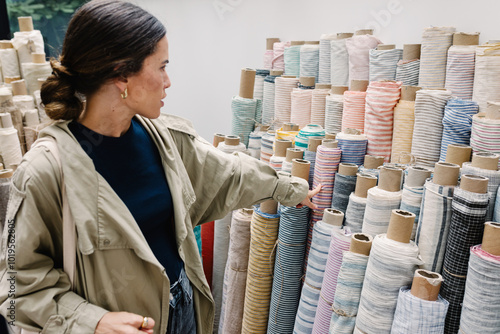 Fashion designer choosing fabrics in a haberdashery in central London photo