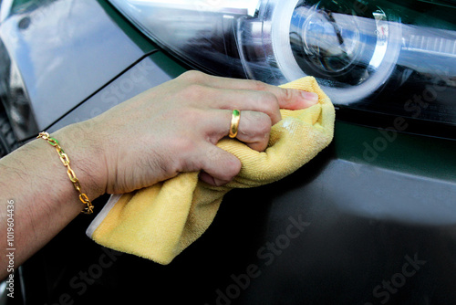 Cleaning the car by using a cloth that prevents dust. photo