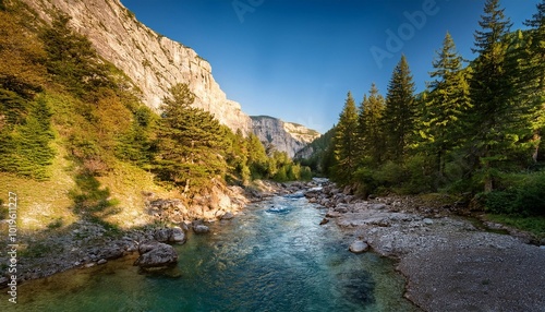 Crystal Clear Mountain Stream Flowing Through a Rocky Canyon, Surrounded by Pine Trees and Majestic Cliffs, Captured in the Early Morning Light for a Stunning Nature Landscape