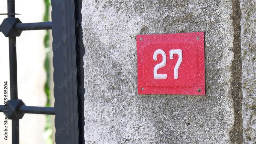 The residence identified as House Number 27 prominently features a concrete surface