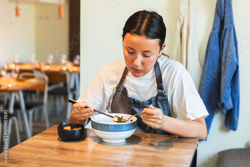 Korean Employee Taking a Break and Eating Soup in Restaurant photo