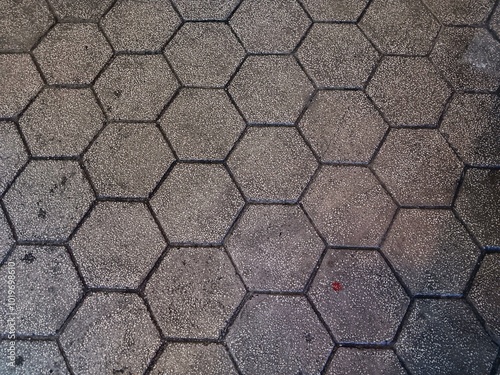 Horizontal image of gray hexagonal paving block as background for copy space. Top view.