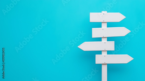 A simple white signpost with multiple directional arrows against a bright blue background.